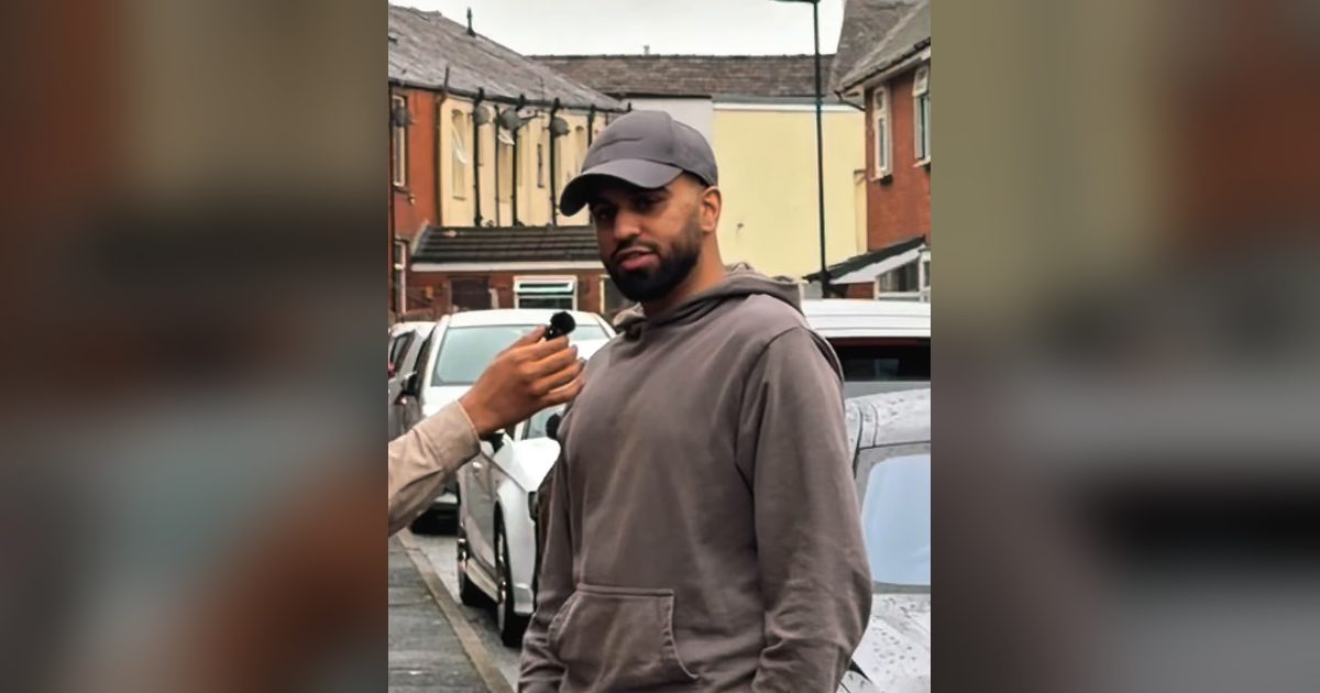 Hassan, an online seller from Rochdale, standing in a residential street in a grey cap and hoodie while answering questions for Angler Fulfilment’s interview.