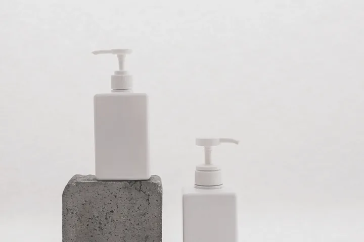 The same two pump bottles straight out of camera, flat and undersaturated.